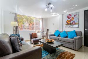 a living room with two couches and a table at Suites 259 Condesa in Mexico City