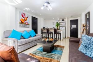 a living room with a couch and a table at Suites 259 Condesa in Mexico City