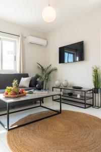 a living room with a couch and a table at Emelia Cozy Apartment in Rhodes Town