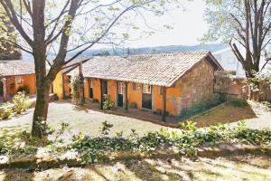 uma casa velha no meio de um quintal em Cottage São Veríssimo 