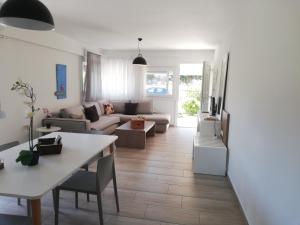 a living room with a couch and a table at My Erofili in Keramoti