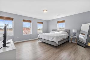 a bedroom with a bed and a desk with a television at Gorgeous Waterfront 3 Bedroom, 1.5 Bathroom Unit. in New Haven