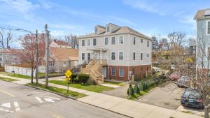 a large white house with a staircase in a street at Gorgeous Waterfront 3 Bedroom, 1.5 Bathroom Unit. in New Haven