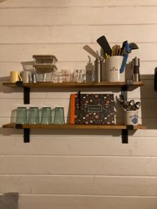 a shelf on a wall with dishes and utensils at Number 15 Frome in Frome