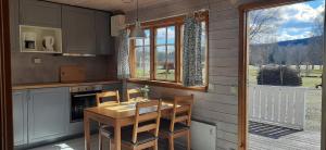 a kitchen with a table and chairs and a window at Björkebo Camping in Stöllet