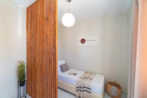 A bed or beds in a room at Emelia Cozy Apartment
