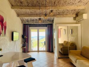 a living room with a couch and a table at Hameau de pietra longa Salvini PORTO-VECCHIO in Sotta