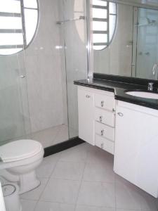 a bathroom with a toilet and a shower and a sink at Luxo in copacabana in Rio de Janeiro