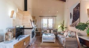 a living room with a couch and a fireplace at Finca Cari in Can Picafort