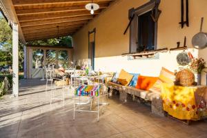 a patio with a couch and chairs and a table at The Old Farm Asfodeli - Adults Only in Sanalvò