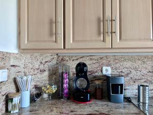 a kitchen counter with a coffee maker on a counter top at Luxury Port View in Lavrio