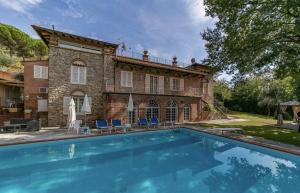 a large swimming pool in front of a house at Maison Brinati Bed and Breakfast in Monsummano Terme