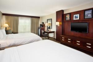 a hotel room with two beds and a flat screen tv at Holiday Inn University Plaza-Bowling Green, an IHG Hotel in Bowling Green