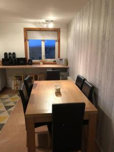 a dining room with a wooden table and chairs at Millstreasm in Pollachar