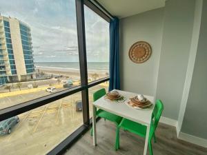 a table and chairs with a view of the beach at Ocean Side Inn Studios in Daytona Beach