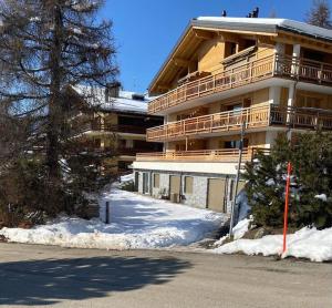 a large apartment building with snow in front of it at Verbier Apt 2 rooms (3 guests) in Verbier