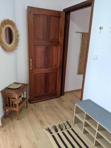 a room with a wooden door and a table at Appartement de charme Chez Soa in Antananarivo