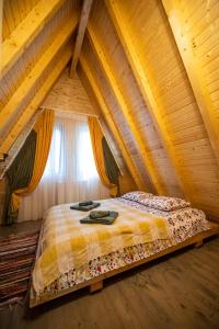 a bedroom with a bed in a attic at Catunul din Podei A-Frame in Dragoslavele