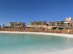 a large swimming pool in front of some buildings at Sea view il monte galala chalet in Ain Sokhna