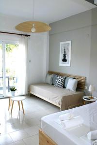 a living room with a bed and a table at Villa Thalassa Apartments in Pefkochori