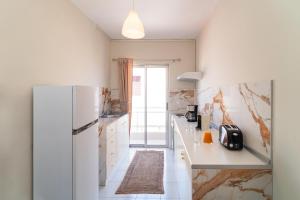 a kitchen with a white refrigerator and a counter at Emelia Cozy Apartment in Rhodes Town
