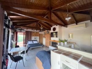 a living room with a bed and a table at Country Lux Apartment near Airport in Markopoulo