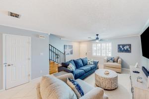 a living room with a couch and a table at Sweet Spot at Woodland Shores in Destin