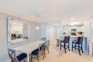a dining room and kitchen with a table and chairs at Sweet Spot at Woodland Shores in Destin