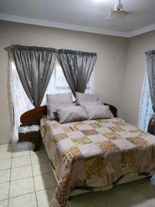 a bedroom with a bed with a quilt on it at 19 Wawiel Guesthouse in Orkney