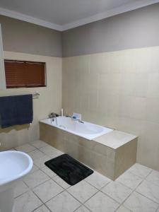 a bathroom with a bath tub and a sink at 19 Wawiel Guesthouse in Orkney