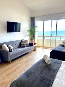 a living room with a couch and a view of the ocean at OceanView & Beach Access 3805 in Cancún