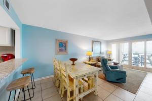 a kitchen and living room with a table and chairs at Castaways 7C in Gulf Shores