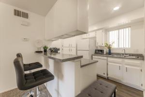 a kitchen with white cabinets and a counter top at "INACTIVE UNBOOKABLE - 5 mins from Disneyland and Convention Center - Your Perfect SoCal Getaway!" in Anaheim