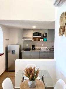 a kitchen with a table and a refrigerator at OceanView & Beach Access 3805 in Cancún