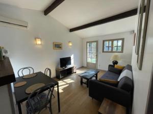 a living room with a couch and a table at Jolie petite maison Avignon - Montfavet in Montfavet