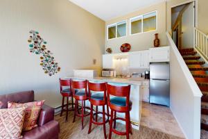 a kitchen with red bar stools and a counter at Mountain Majesty in Stateline
