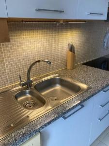 a stainless steel sink in a kitchen at Royal Cabanas Gold penthouseT2 in Conceição