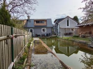 a house with a canal in front of it at Apartmány Svatá in Svatá