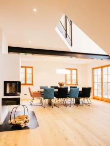 a living room with a table and chairs and a fireplace at Wolke 9A in Traunstein