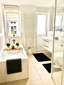 a white bathroom with a sink and a shower at Stadt Villa Rastatt in Rastatt