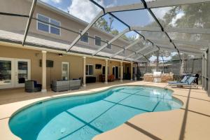 a swimming pool in front of a house at Contemporary Brandon Home with Pool and Game Room in Brandon
