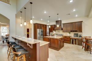 a large kitchen with wooden cabinets and a large island at Contemporary Brandon Home with Pool and Game Room in Brandon