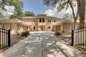 a large house with a gate and a driveway at Contemporary Brandon Home with Pool and Game Room in Brandon