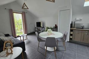 a living room with a white table and chairs at La Grande Mouette in Thonon-les-Bains +11 photos