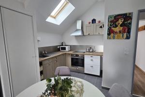 a kitchen with a white table and a kitchen with a tableablish at La Grande Mouette in Thonon-les-Bains