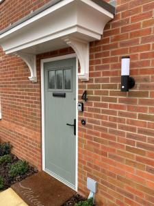 a brick house with a white door on it at Comfortable new home in Isleham in Ely