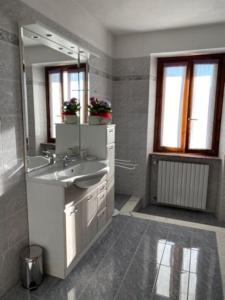 a bathroom with a sink and a mirror at Appartamento Angolo Fiorito in Provaglio Val Sabbia