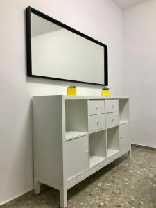 a white dresser with a mirror on a wall at Light in Vila-real, central apartment with office in Villareal