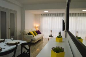 ein Wohnzimmer mit einem weißen Sofa und einem Tisch in der Unterkunft Light in Vila-real, central apartment with office in Villareal