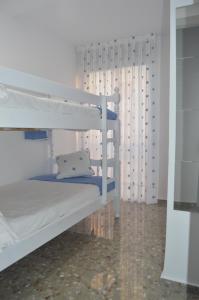 a bedroom with two bunk beds and a curtain at Light in Vila-real, central apartment with office in Villareal